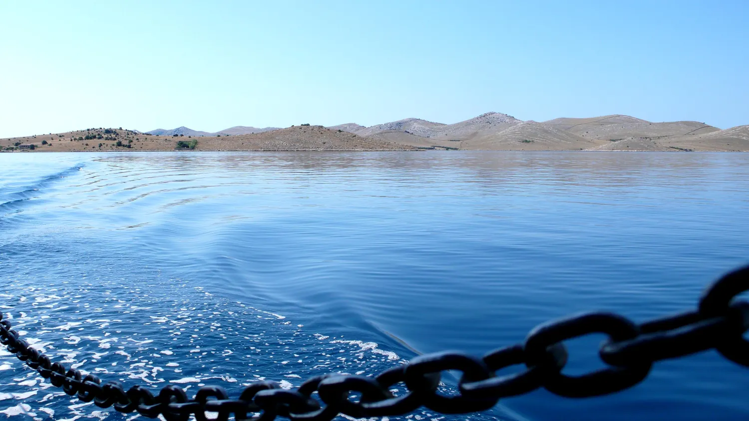 Bare uninhabited islands of Kornati National Park seen from the deck of a boat, Croatia