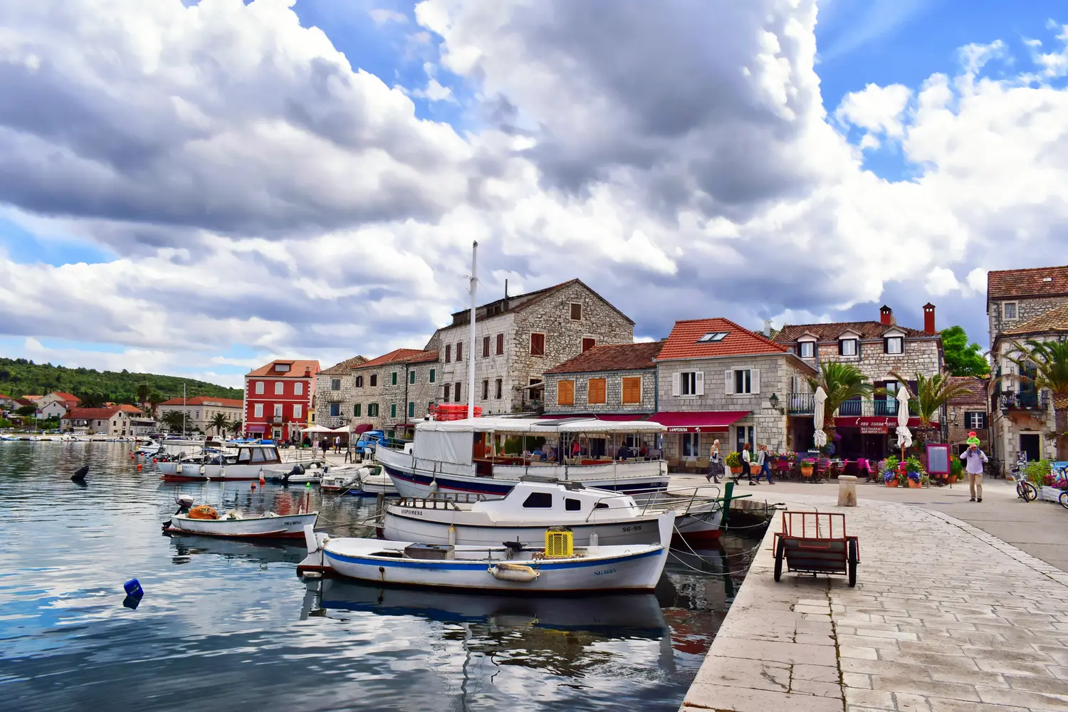 Stone houses and small fishing boats along the quiet harbour of Stari Grad on the island of Hvar, Croatia