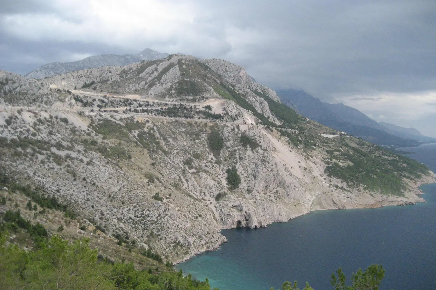 The Jadranska magistrala coastal road cut into the steep karst slope high above the Adriatic, Croatia