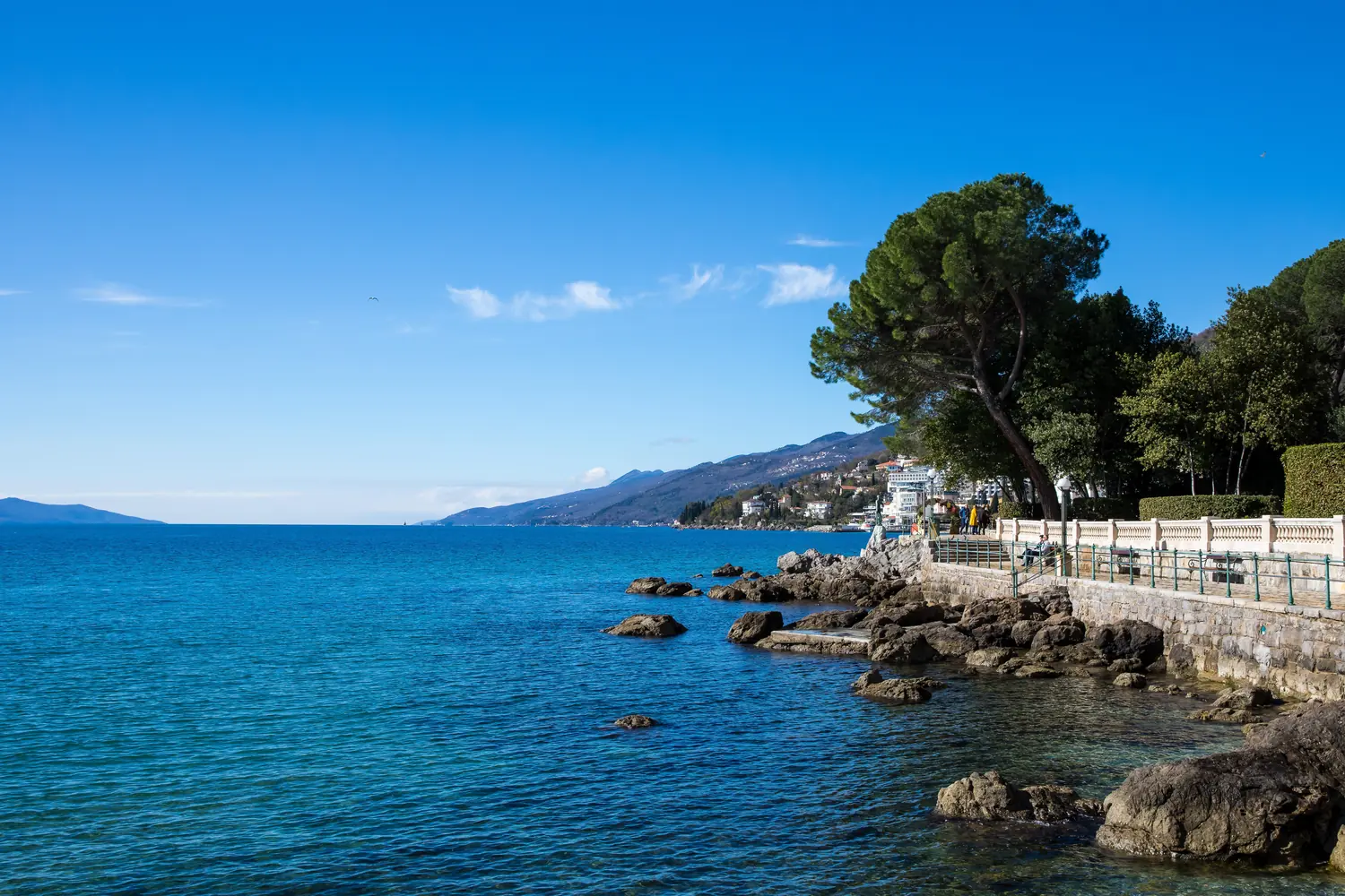 Clear turquoise water along the rocky shore promenade of the Opatija riviera in Kvarner, Croatia