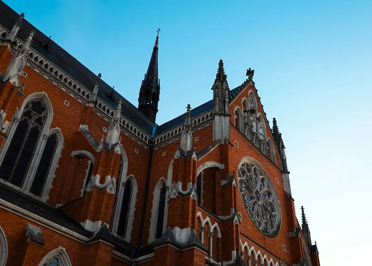 Red brick neo-Gothic cathedral of Saints Peter and Paul in Osijek against a blue sky