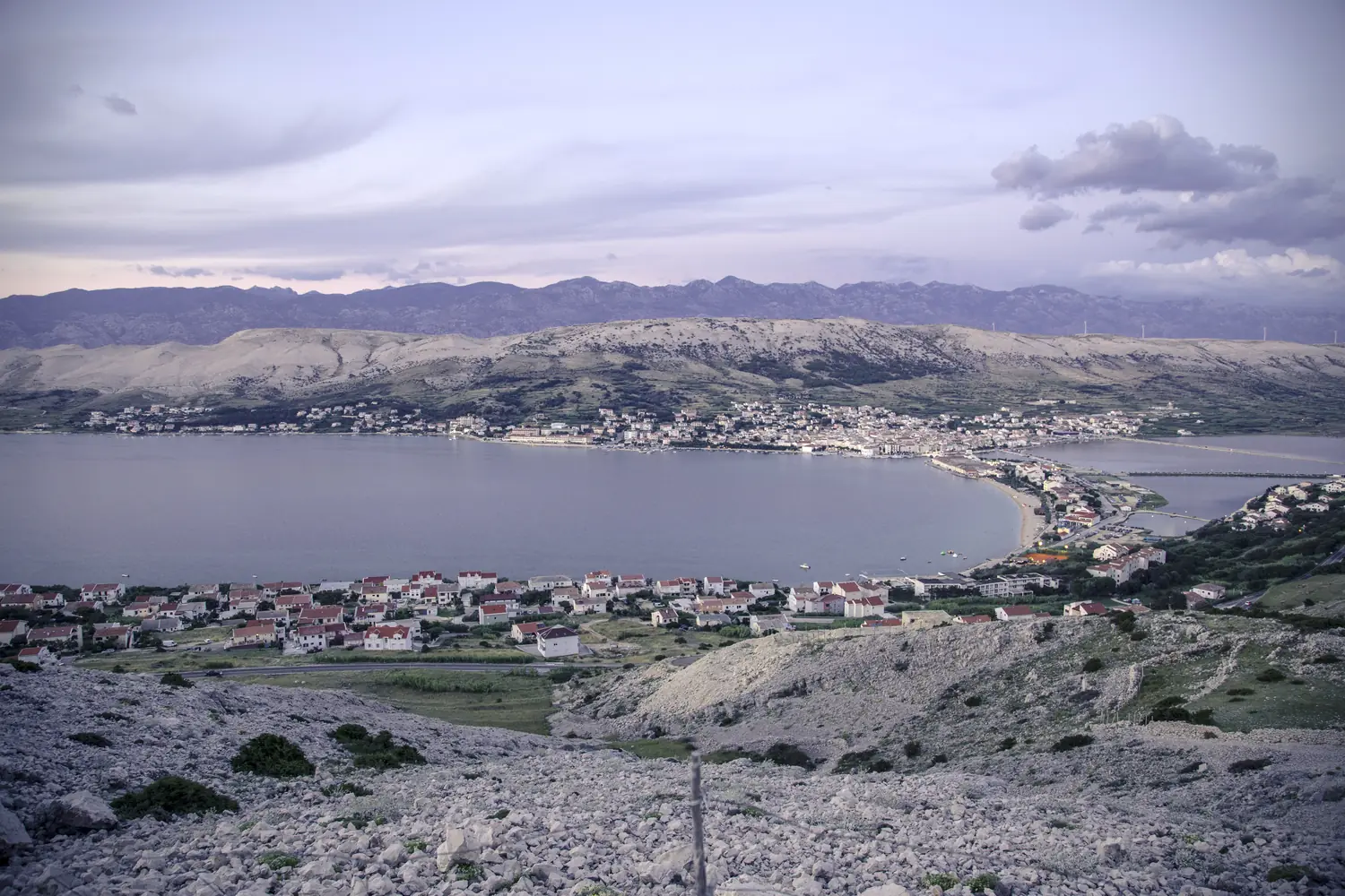 Bare white karst hills above a bay on the island of Pag, Croatia, with almost no vegetation
