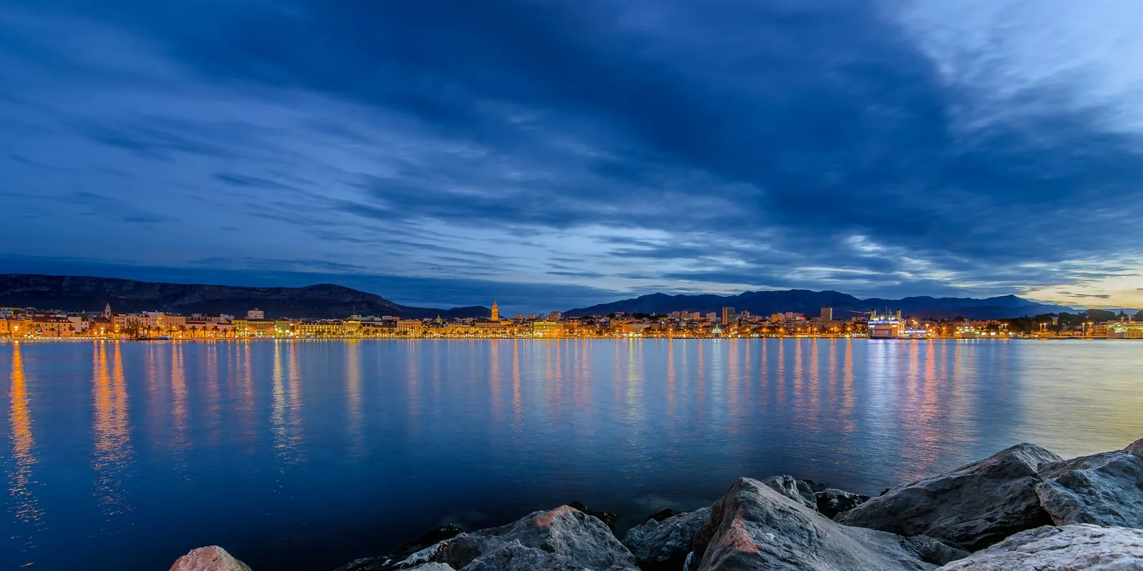Panorama of Split and its harbour at blue hour with the Dalmatian coast stretching away, Croatia